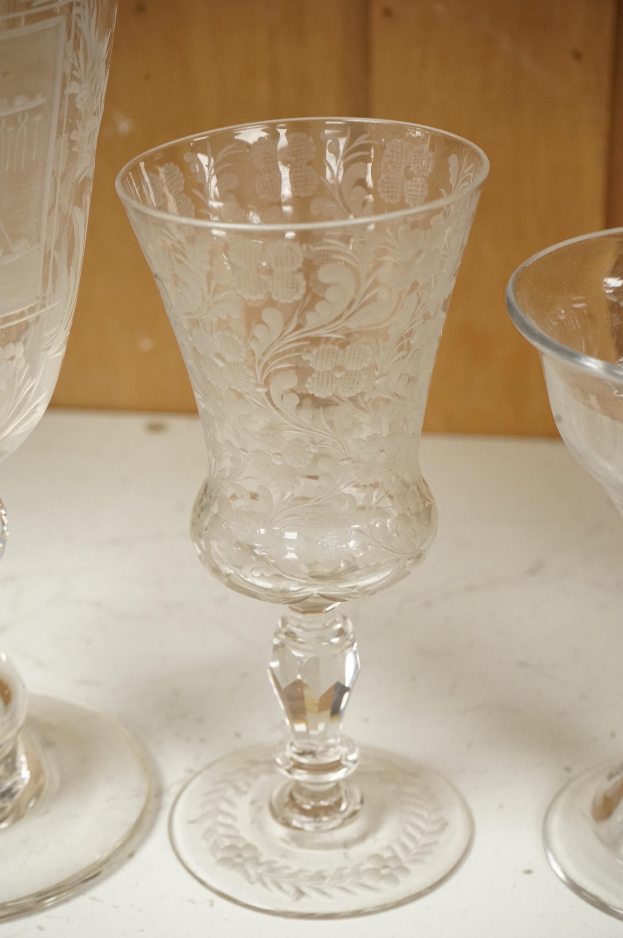 An 18th century sweetmeat glass, a 19th century large wheel engraved ‘Gretna Green’ goblet and a smaller floral engraved glass, tallest 23cm